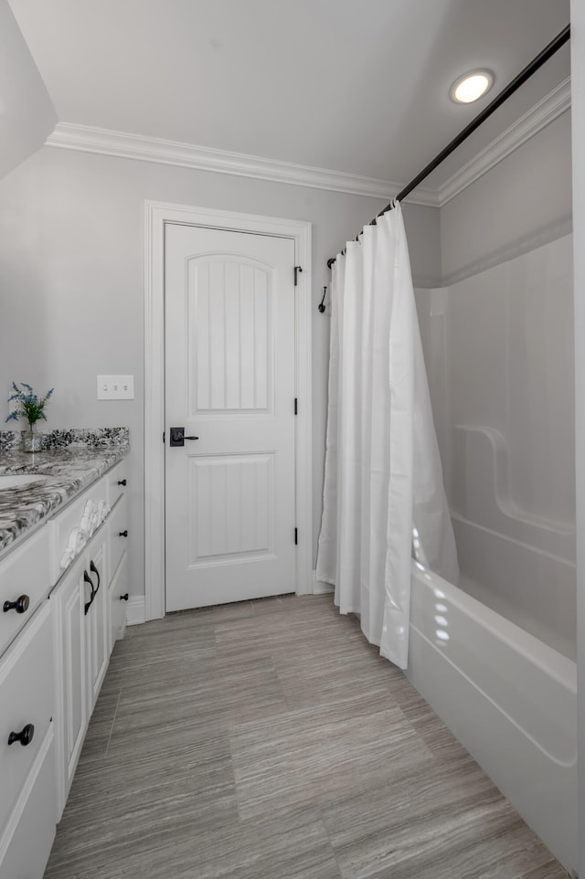 full bathroom with shower / tub combo, crown molding, and vanity