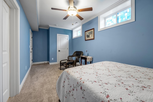 carpeted bedroom featuring a ceiling fan, baseboards, visible vents, and crown molding