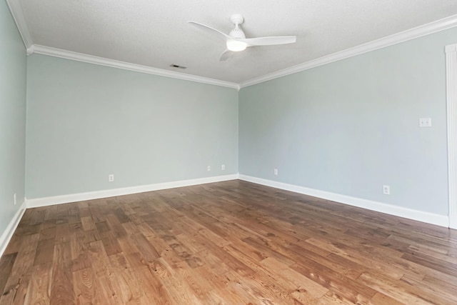 spare room featuring baseboards, crown molding, a ceiling fan, and wood finished floors