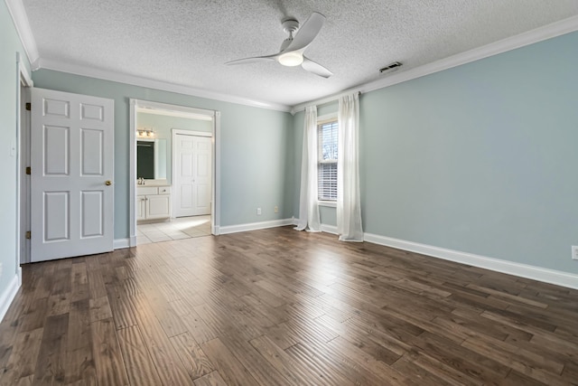 unfurnished room featuring dark wood-style flooring, visible vents, ornamental molding, a ceiling fan, and baseboards