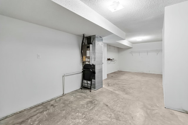 finished basement featuring a textured ceiling