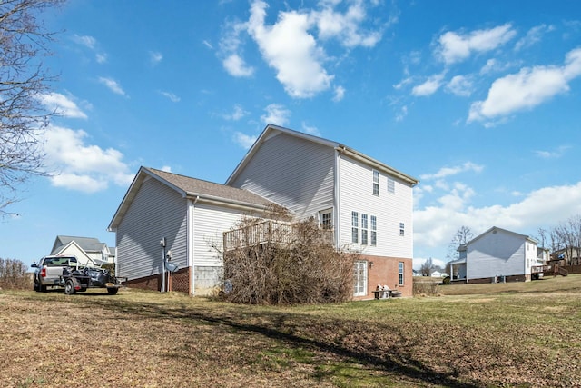 view of side of home with a lawn