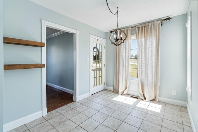 unfurnished dining area with an inviting chandelier, baseboards, and light tile patterned flooring