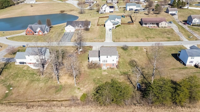 birds eye view of property with a water view and a residential view