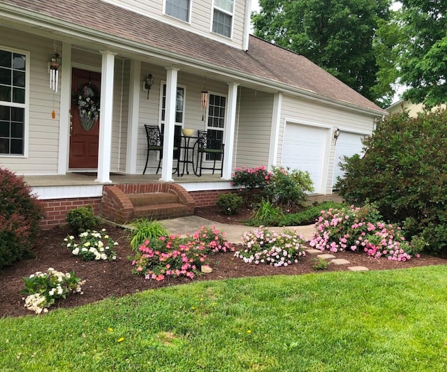 view of front of home featuring a garage, a porch, and roof with shingles