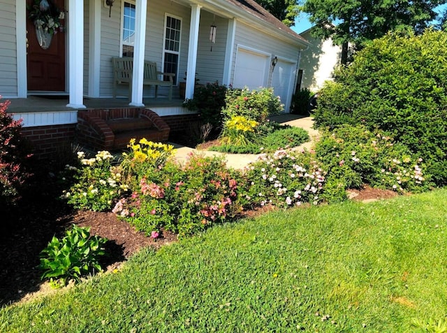 view of yard with a garage and covered porch