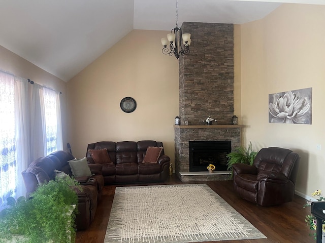 living room with baseboards, a chandelier, a stone fireplace, wood finished floors, and high vaulted ceiling