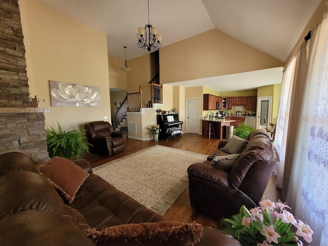 living area featuring visible vents, high vaulted ceiling, stairway, an inviting chandelier, and dark wood-style flooring