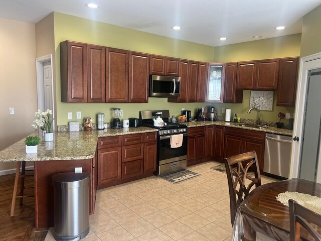 dining area featuring a notable chandelier, baseboards, and light tile patterned floors