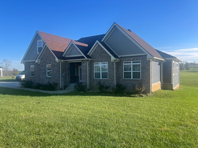 craftsman inspired home with a front yard and brick siding