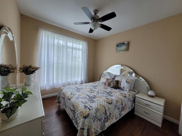 bedroom featuring dark wood finished floors, ceiling fan, and baseboards