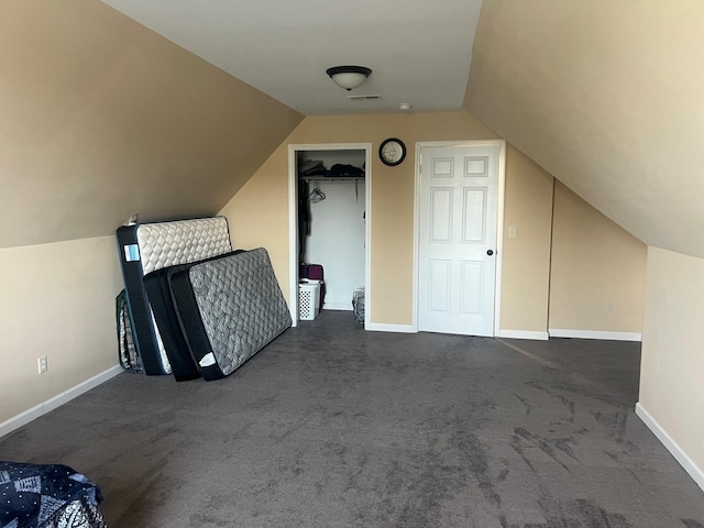 additional living space with baseboards, lofted ceiling, and carpet flooring