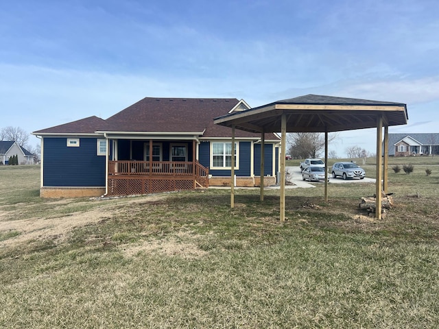 back of property with a carport, a lawn, and a porch