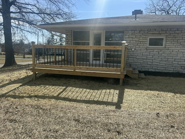 rear view of property with a shingled roof and a chimney