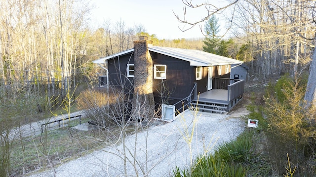 view of front of home with metal roof and a chimney