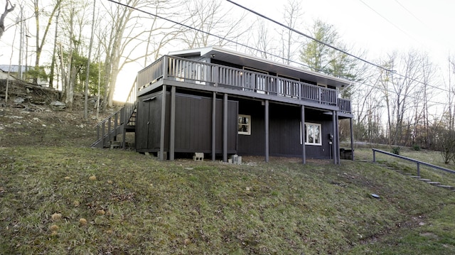 rear view of house featuring stairway and a wooden deck