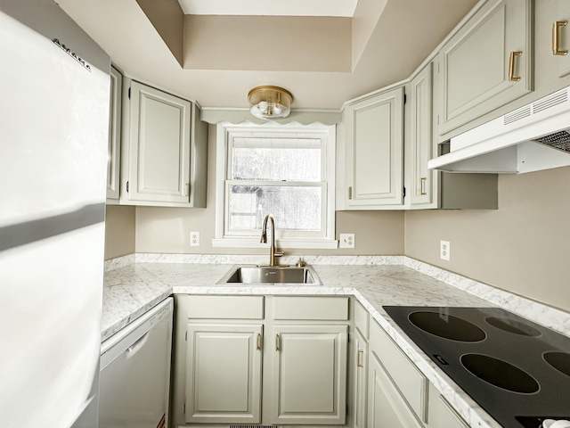 kitchen with a sink, white appliances, under cabinet range hood, and light countertops