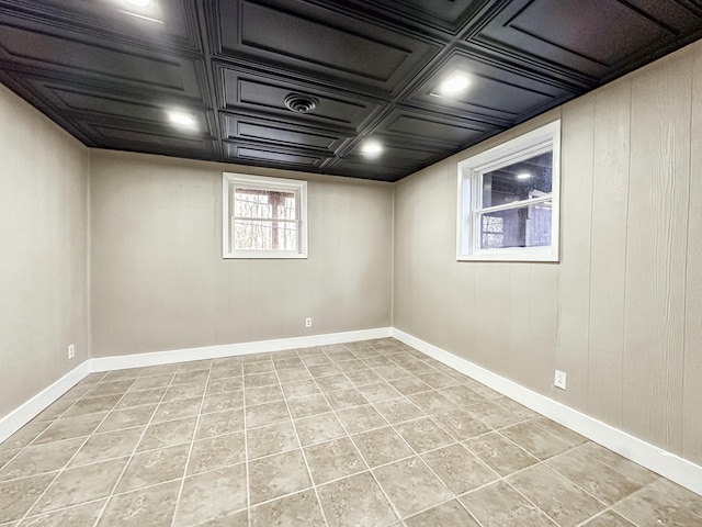 below grade area with light tile patterned floors and baseboards