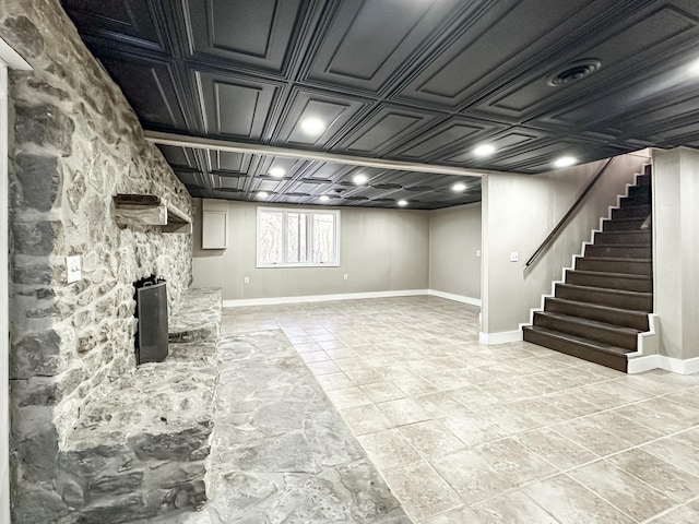 below grade area with stairway, baseboards, and an ornate ceiling