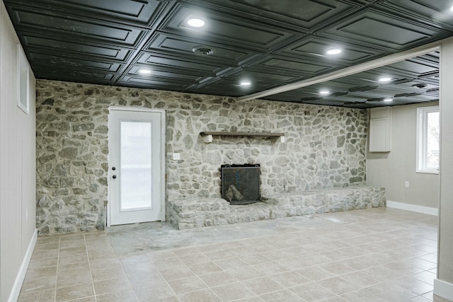 basement with light tile patterned flooring and baseboards