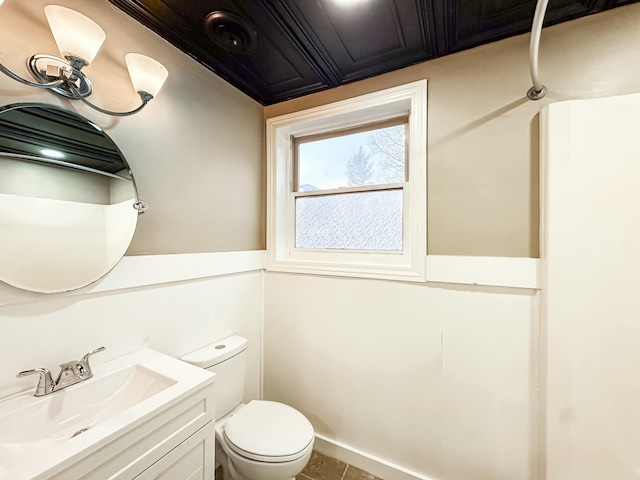 bathroom featuring toilet and vanity