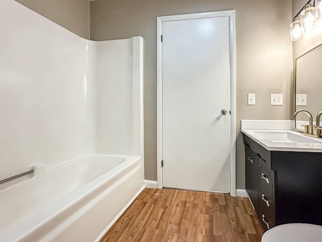 full bathroom with shower / bath combination, wood finished floors, and vanity