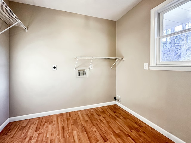 clothes washing area with laundry area, hookup for a washing machine, baseboards, and hookup for an electric dryer