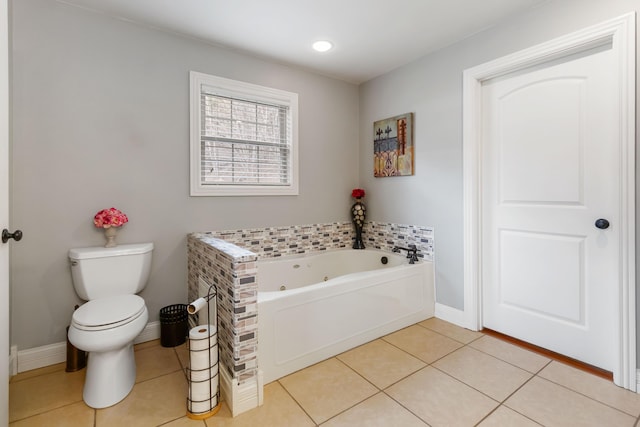 full bath featuring a whirlpool tub, baseboards, toilet, and tile patterned floors