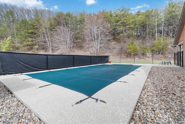 view of swimming pool featuring a fenced in pool and fence