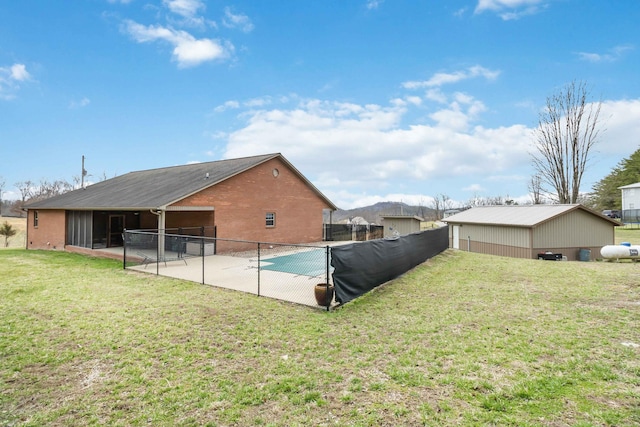 view of pool with a patio area, a lawn, and fence