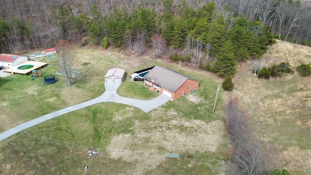 drone / aerial view featuring a wooded view