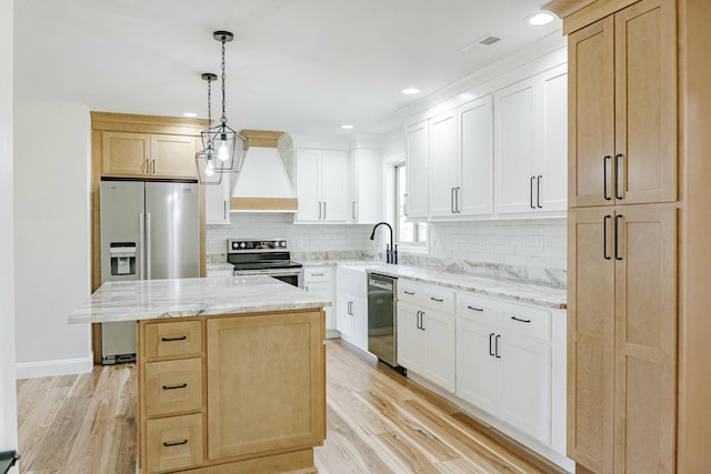 kitchen featuring custom exhaust hood, light wood-style floors, tasteful backsplash, and stainless steel appliances