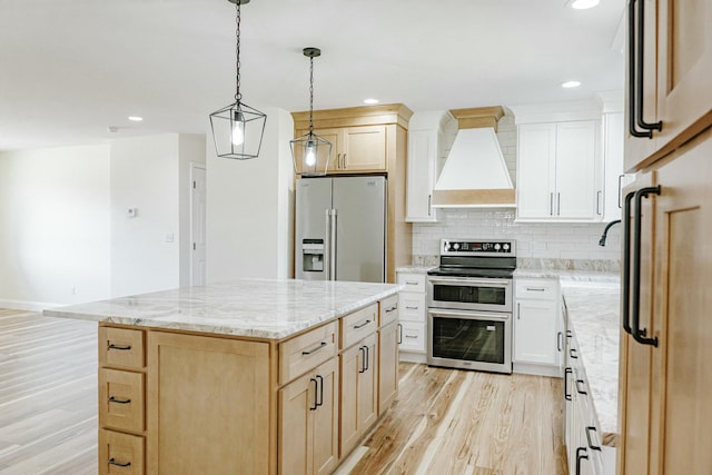 kitchen featuring light stone counters, premium range hood, light wood-style flooring, stainless steel appliances, and tasteful backsplash