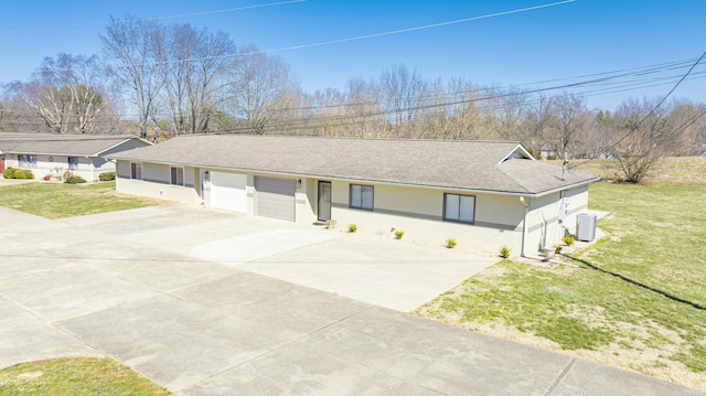 single story home featuring stucco siding, central air condition unit, a garage, and a front lawn