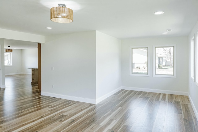 spare room with recessed lighting, visible vents, baseboards, and light wood finished floors