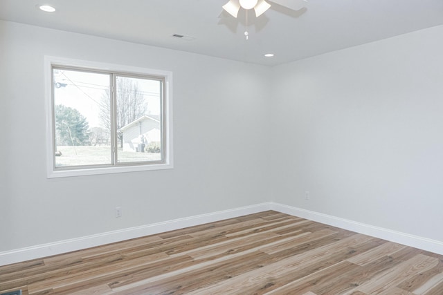 spare room featuring light wood finished floors, visible vents, recessed lighting, and baseboards