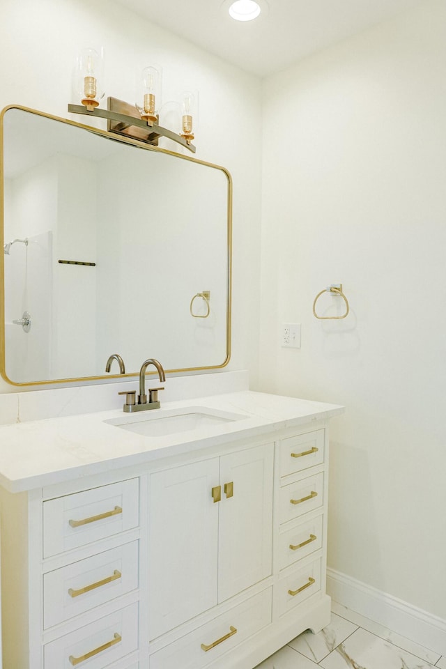 bathroom with recessed lighting, marble finish floor, vanity, and baseboards