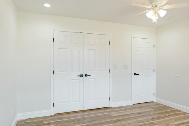 unfurnished bedroom with a ceiling fan, baseboards, recessed lighting, light wood-style floors, and a closet