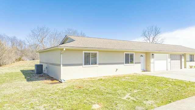 ranch-style home featuring a front yard, stucco siding, cooling unit, a garage, and driveway