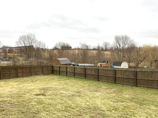 view of yard featuring fence and an outdoor structure