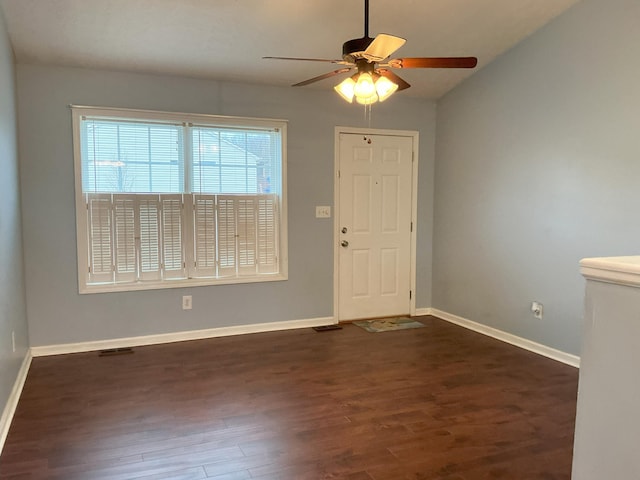 entrance foyer with dark wood-style floors, visible vents, ceiling fan, and baseboards