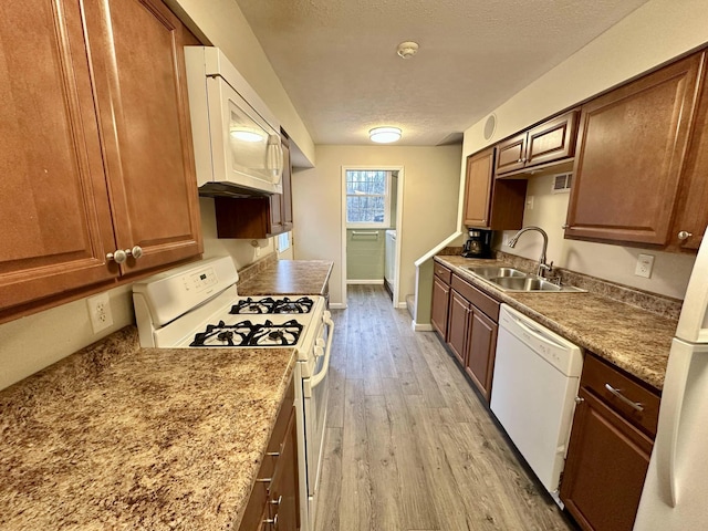 185 Woods Rd, Nancy, KY 42544 - kitchen with white appliances, light wood-style flooring, a sink, baseboards, and a textured ceiling