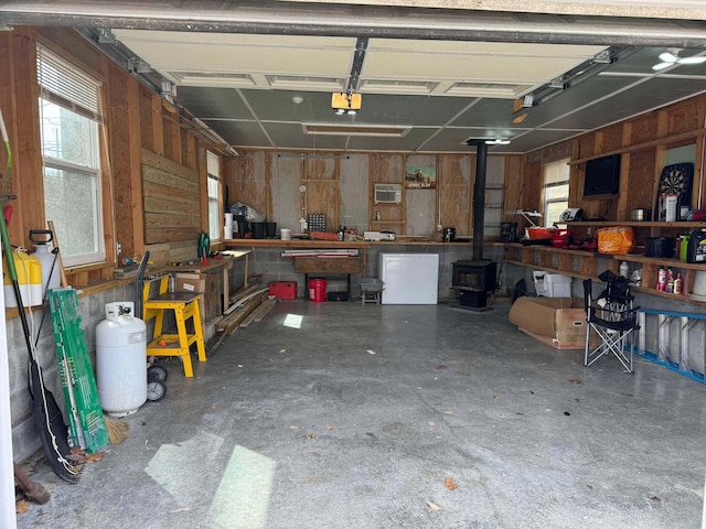 garage featuring wood walls and a workshop area