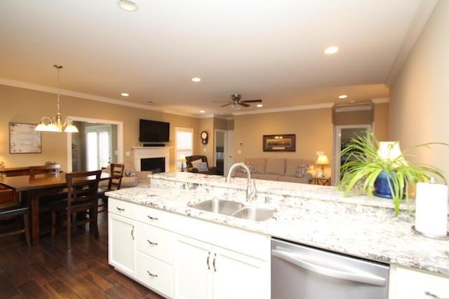 kitchen with dark wood-style flooring, a fireplace, open floor plan, a sink, and dishwasher