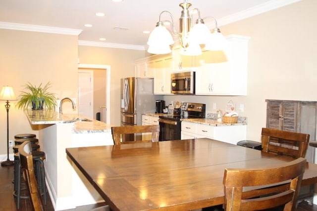 dining area with recessed lighting, a notable chandelier, and crown molding