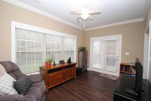 sitting room with visible vents, ornamental molding, dark wood-style flooring, and a ceiling fan