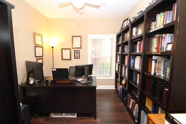 office space with a ceiling fan, wood tiled floor, and baseboards