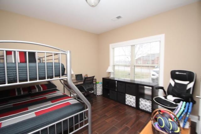 bedroom with visible vents and wood finished floors