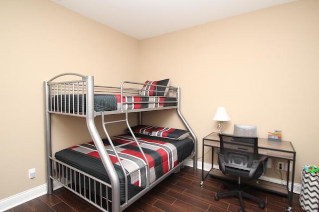 bedroom featuring wood finished floors and baseboards