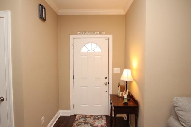 entrance foyer featuring dark wood finished floors, crown molding, and baseboards